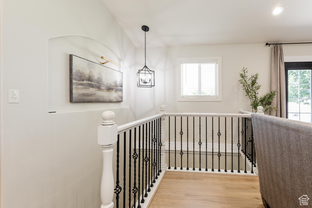 Staircase featuring wood finished floors and recessed lighting