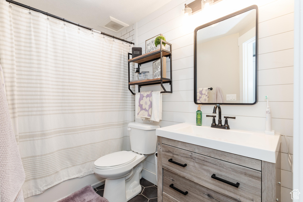 Full bath with vanity, tile patterned flooring, and curtained shower
