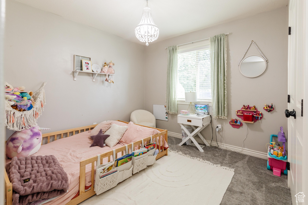 Bedroom featuring carpet and a chandelier