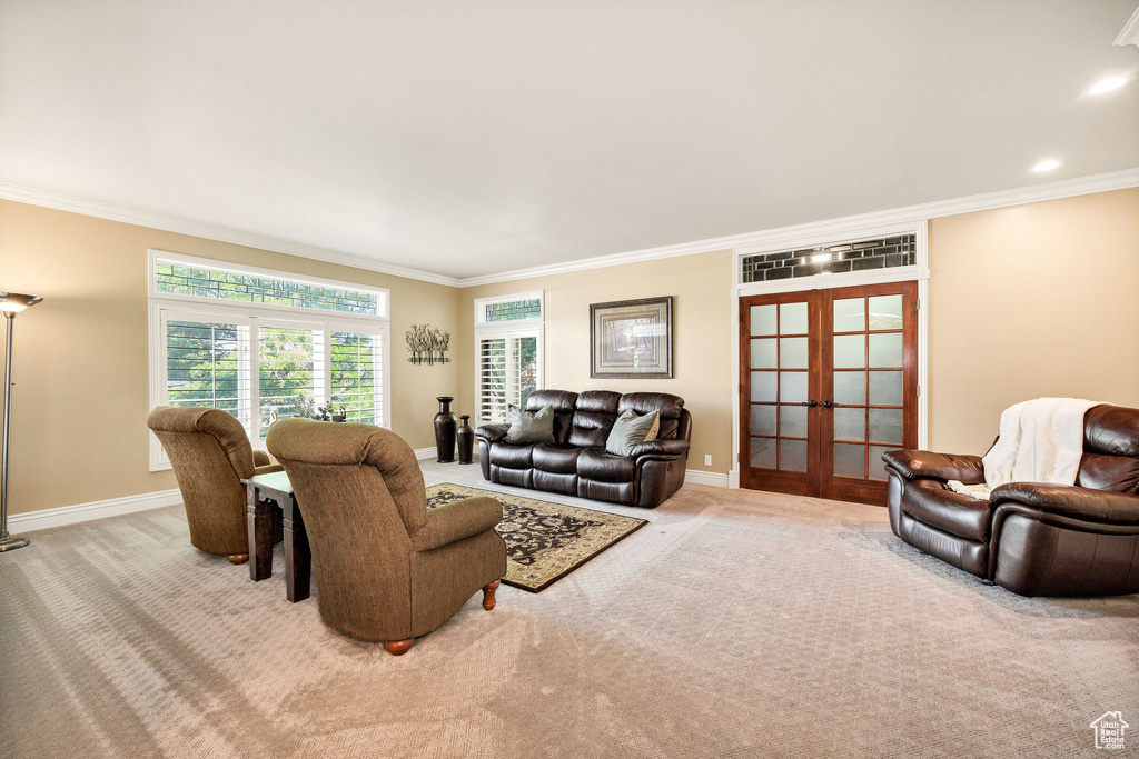 Carpeted living room featuring french doors and crown molding