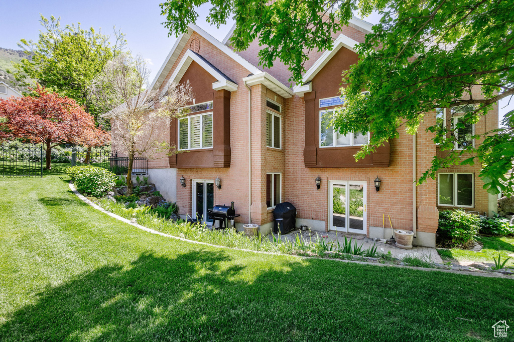 Back of house featuring brick siding