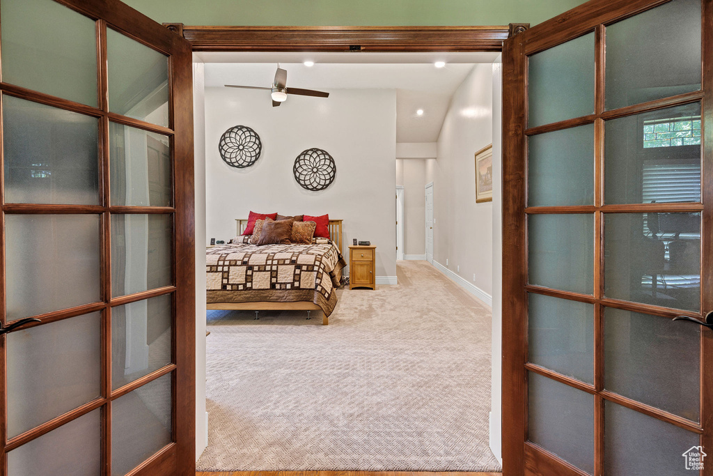 Carpeted bedroom with baseboards and french doors