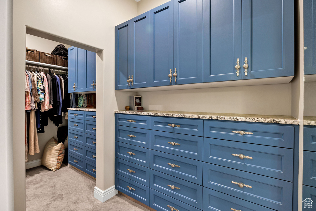 Walk in closet featuring light carpet