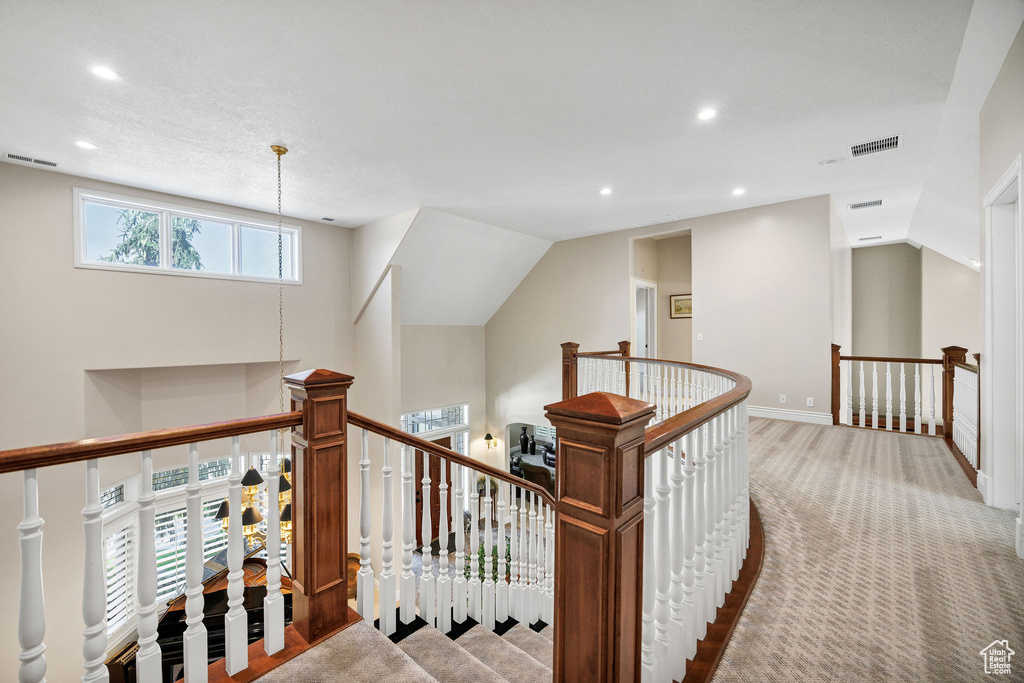 Hall featuring an upstairs landing, recessed lighting, and carpet flooring