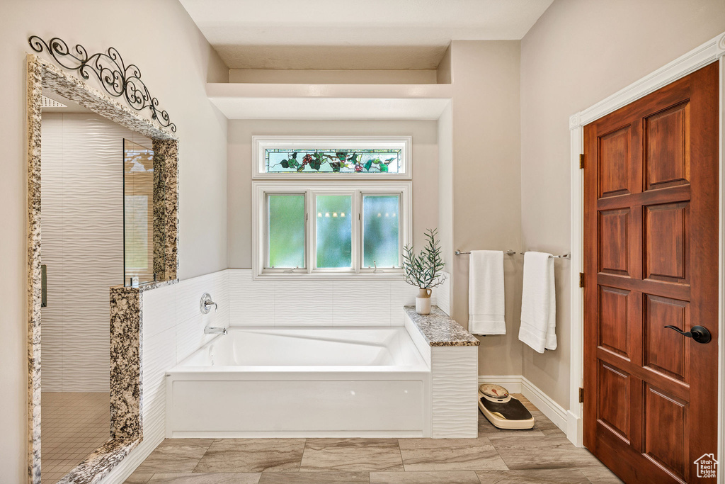 Bathroom with a bath and a shower stall