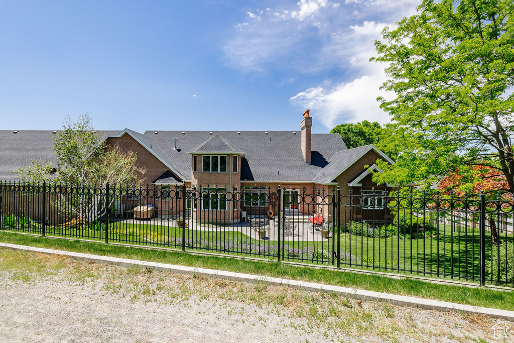 Back of house with a patio and a chimney