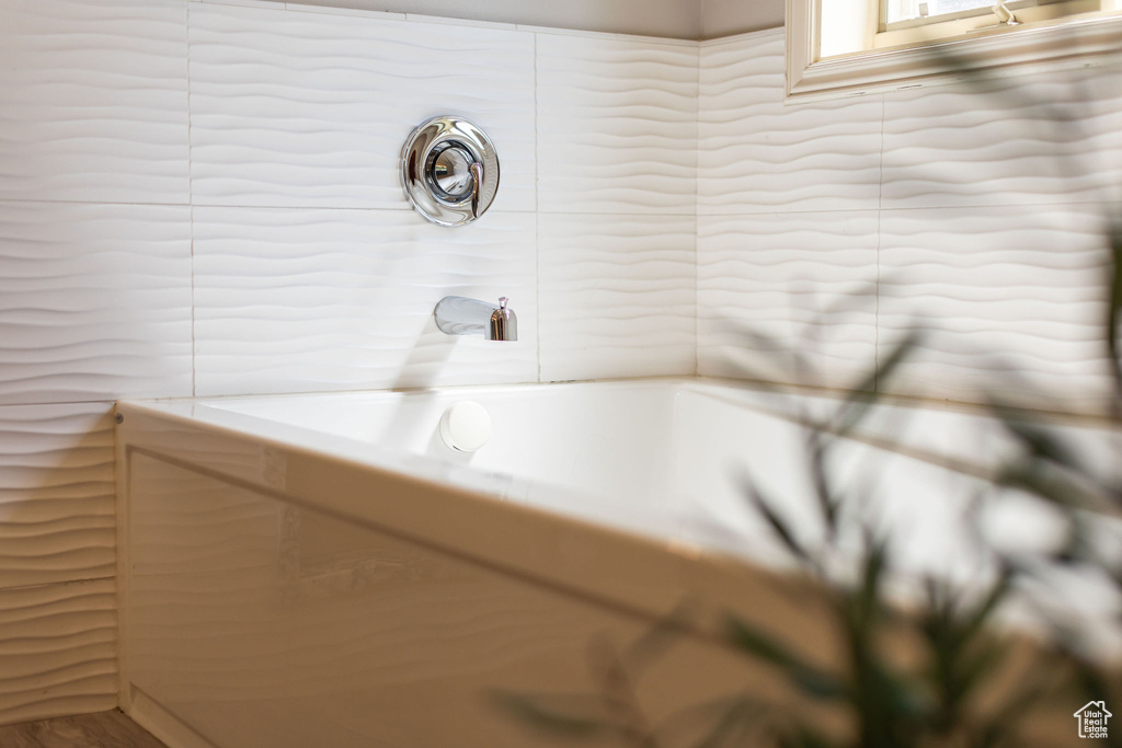 Full bathroom with tile walls