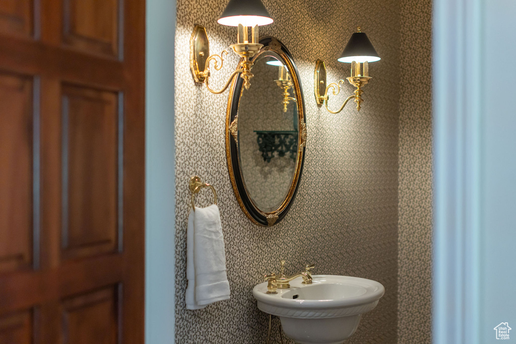 Bathroom featuring a sink and a chandelier