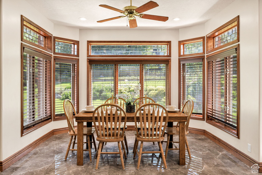 Dining area featuring marble tiled floors, healthy amount of natural light, a ceiling fan, and recessed lighting