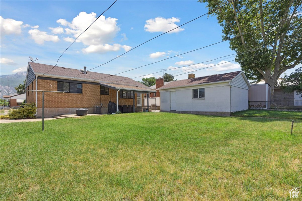 Back of property featuring brick siding