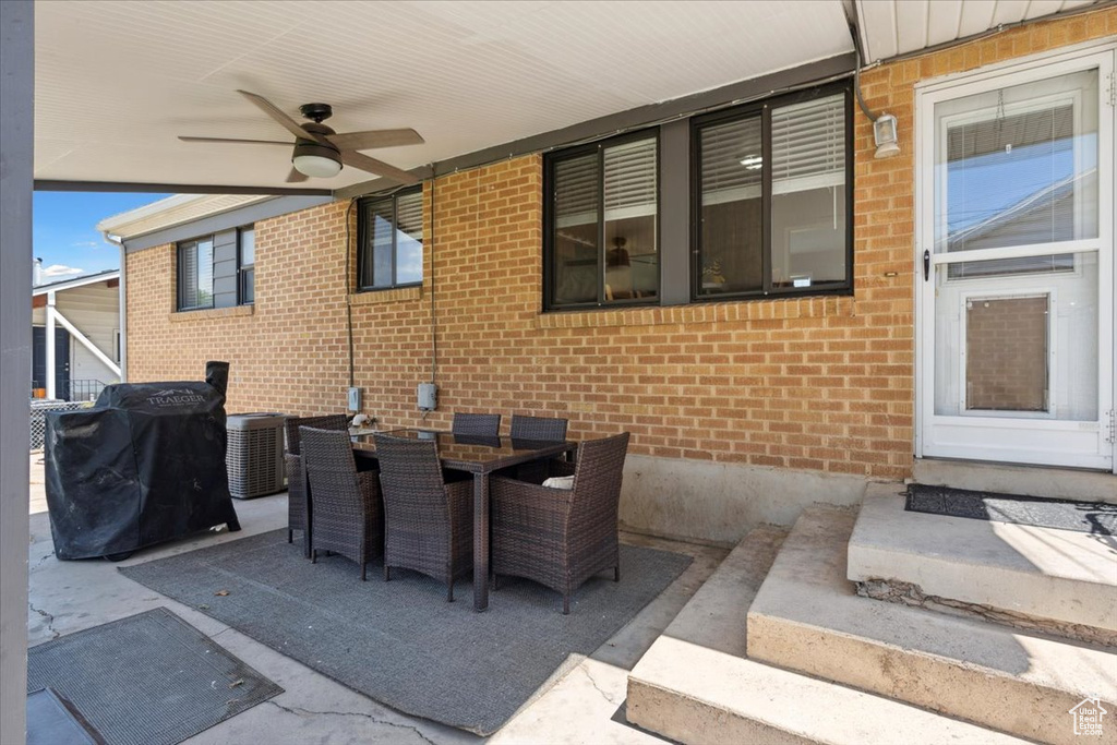 View of patio featuring ceiling fan, grilling area, and outdoor dining space