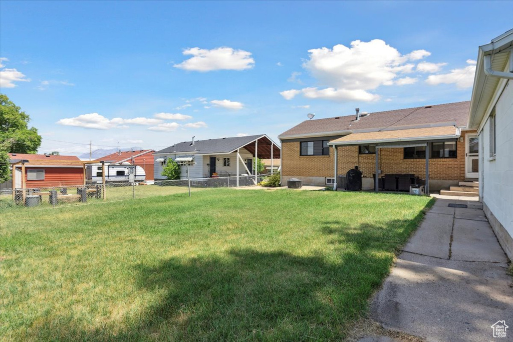Fenced backyard with entry steps and a residential view