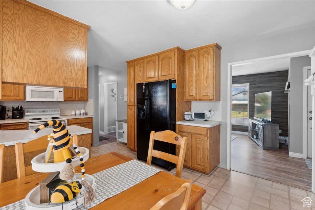 Kitchen with white appliances, light countertops, and decorative backsplash