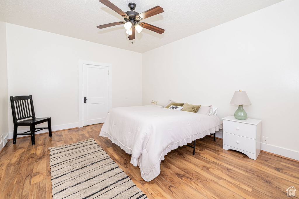 Bedroom with light wood finished floors and ceiling fan