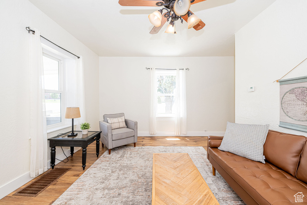 Living area featuring ceiling fan and light wood-style flooring