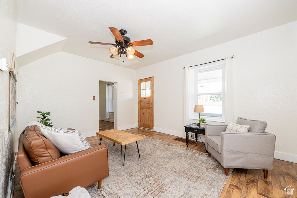 Living room with ceiling fan and wood finished floors