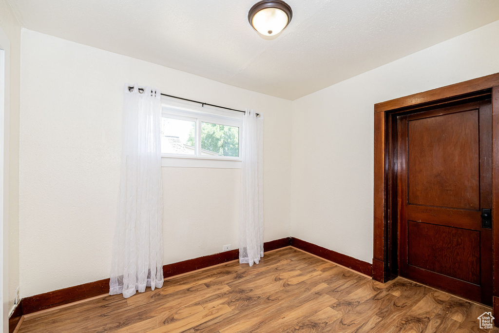 Empty room featuring baseboards and light wood-style floors
