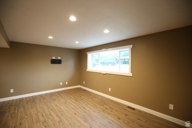 Empty room with recessed lighting and wood finished floors