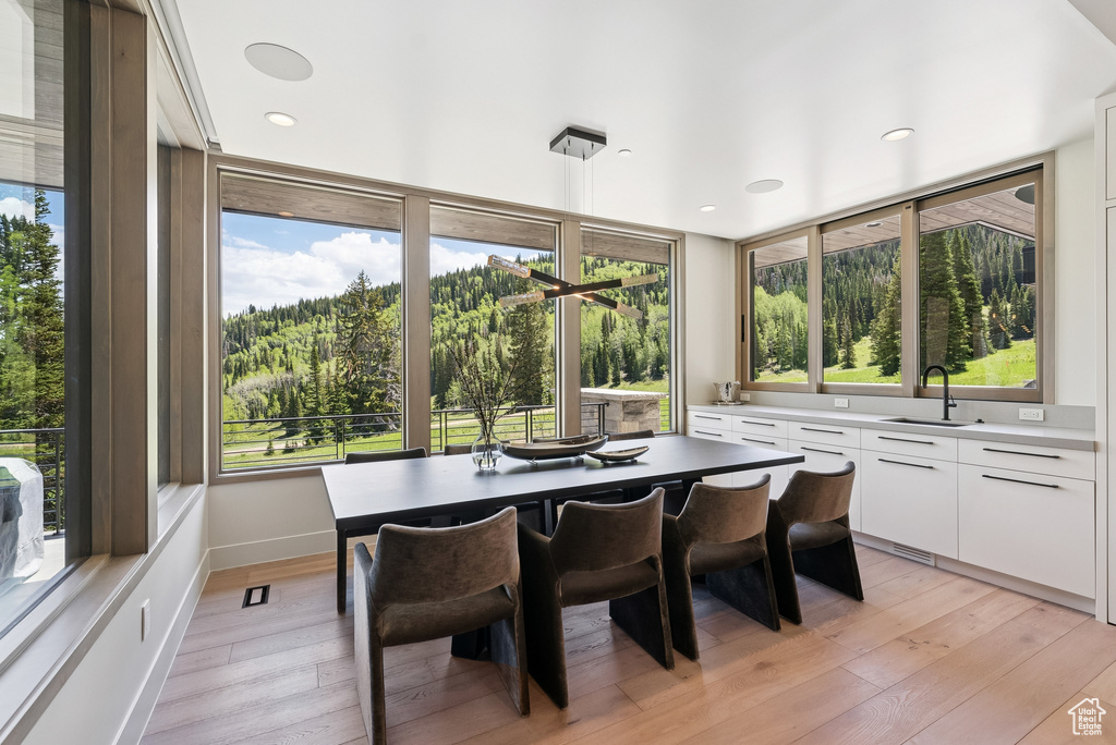 Dining area featuring plenty of natural light, light wood-style flooring, and recessed lighting