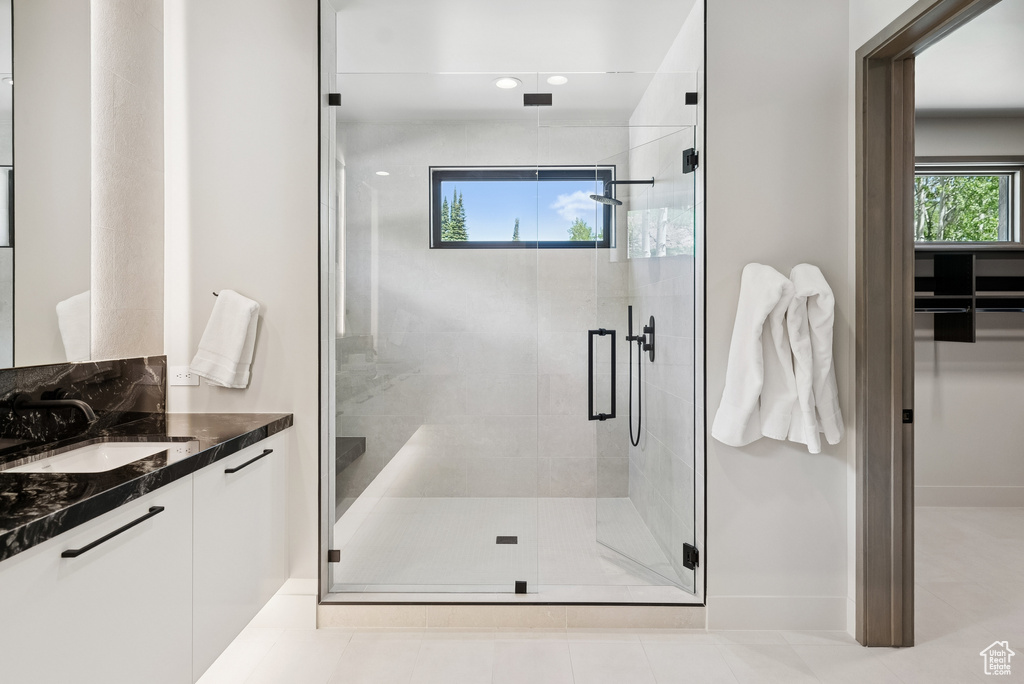 Bathroom featuring vanity, a stall shower, and recessed lighting