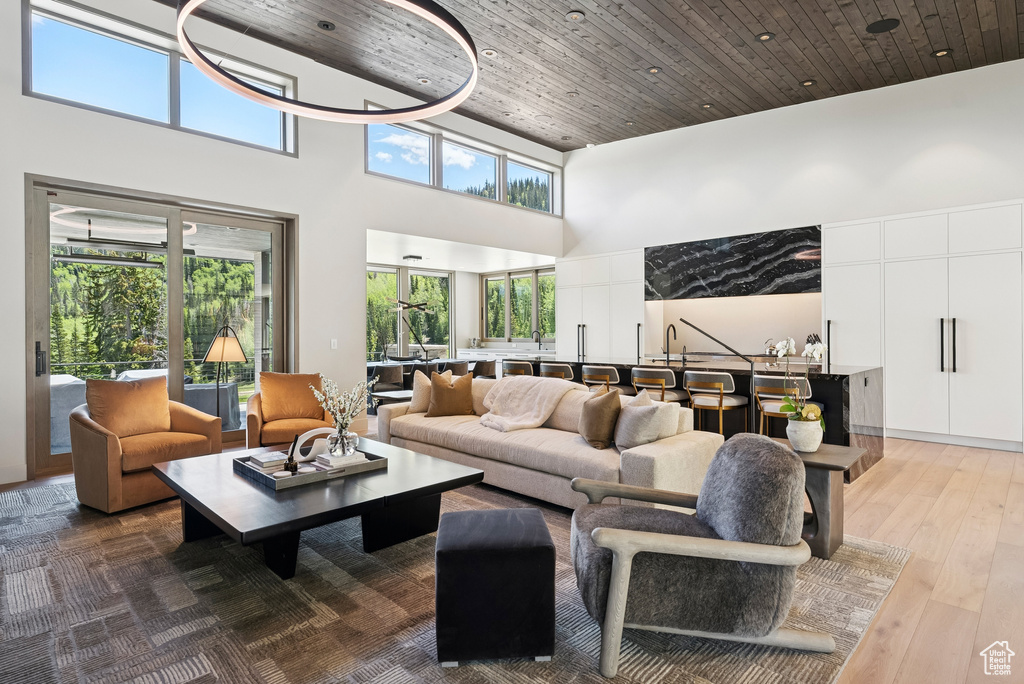 Living room featuring a high ceiling and wood finished floors