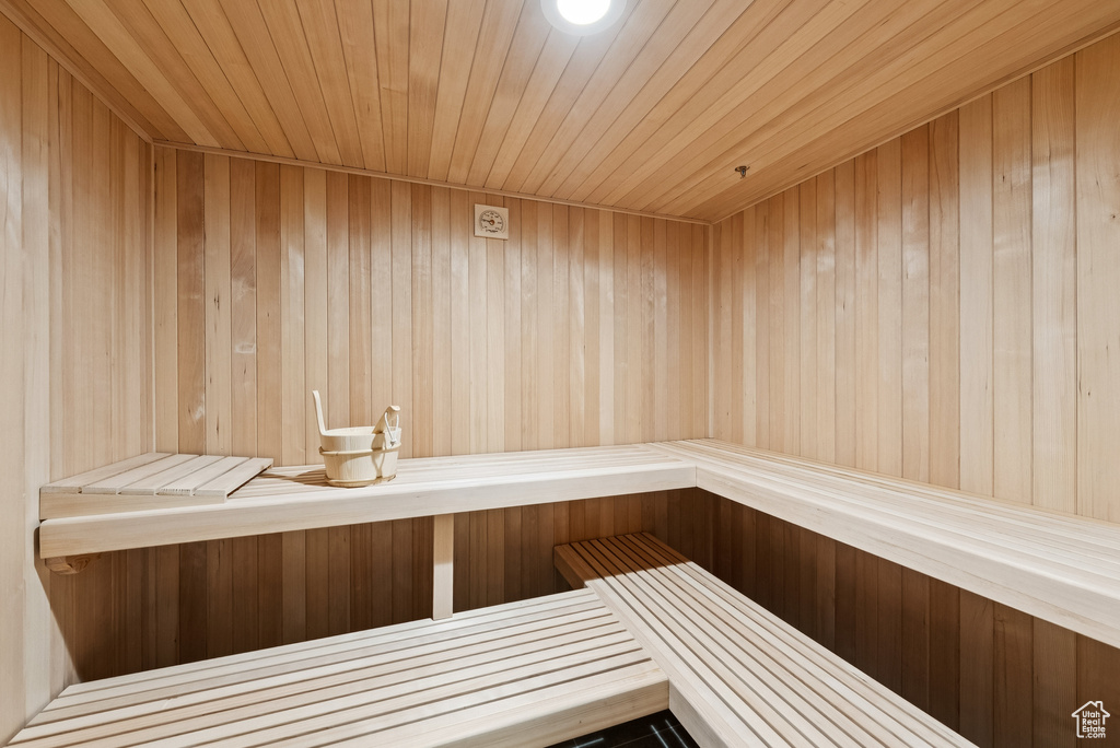 Sauna / steam room featuring wooden ceiling and wood walls