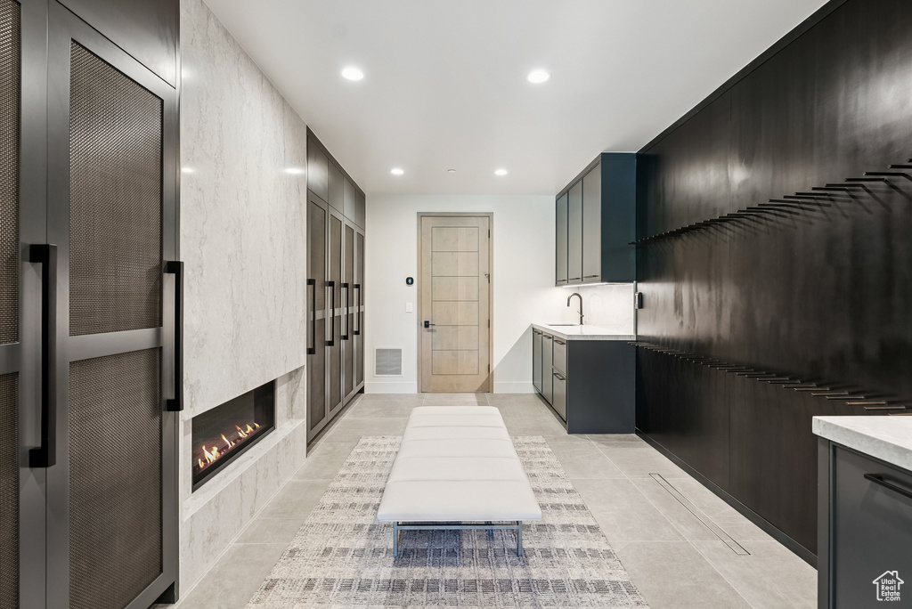 Kitchen with light countertops, recessed lighting, light tile patterned flooring, a heating unit, and a fireplace