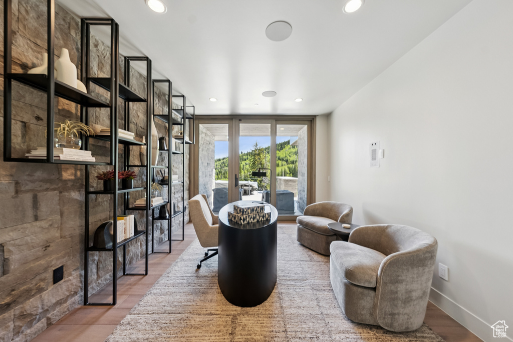 Living area with wood finished floors and recessed lighting