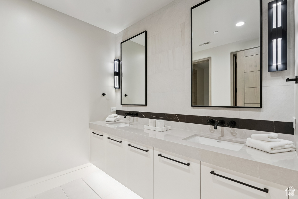 Full bathroom with double vanity and tile patterned floors