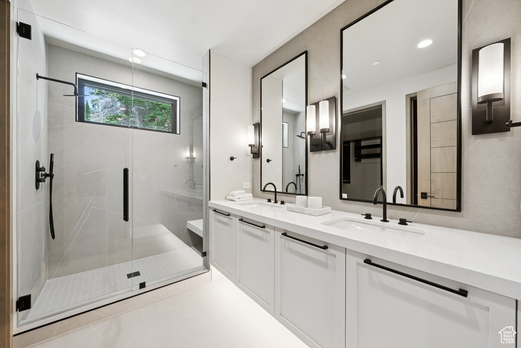 Bathroom with double vanity and a stall shower