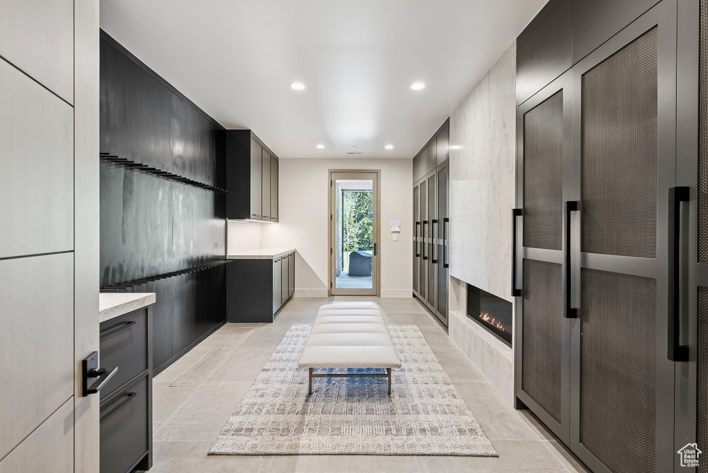 Kitchen with light countertops, recessed lighting, a heating unit, modern cabinets, and light tile patterned floors