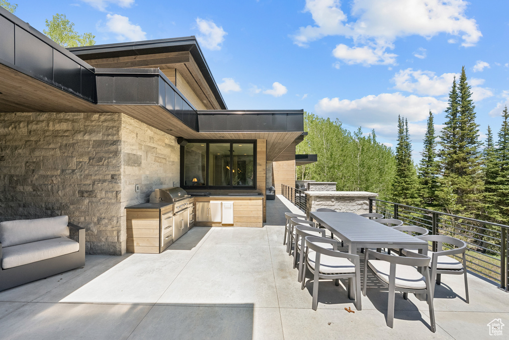 View of patio featuring an outdoor kitchen and outdoor dining area