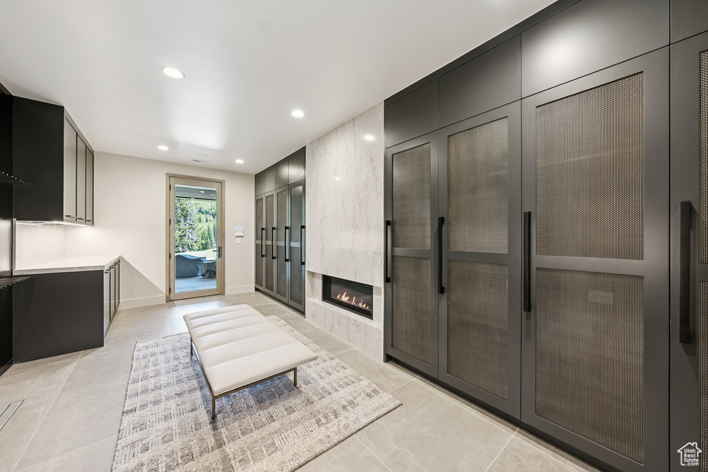 Living area featuring recessed lighting, a fireplace, light tile patterned floors, and french doors