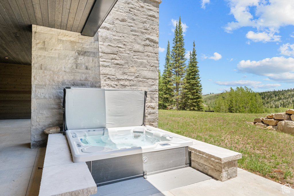 View of patio featuring a hot tub