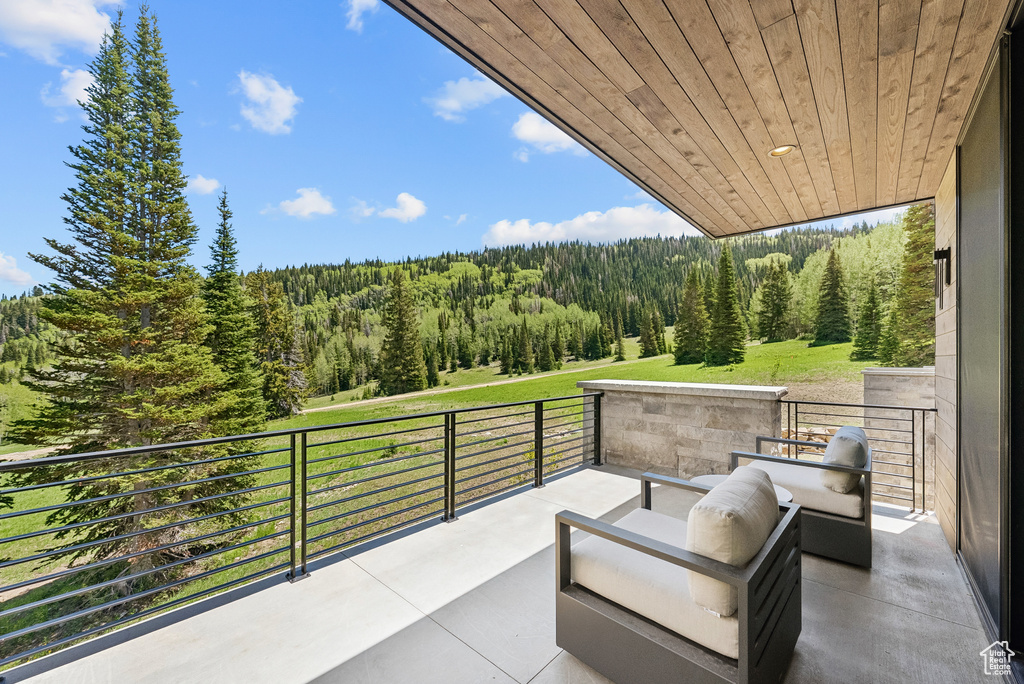 Patio / terrace featuring a forest view