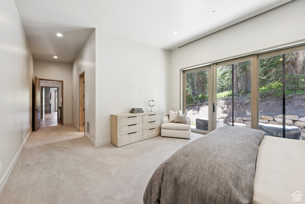 Bedroom featuring access to exterior, light carpet, and recessed lighting