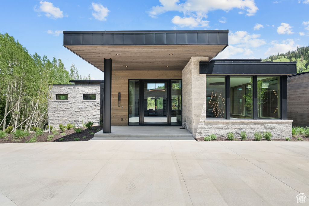 Entrance to property featuring stone siding