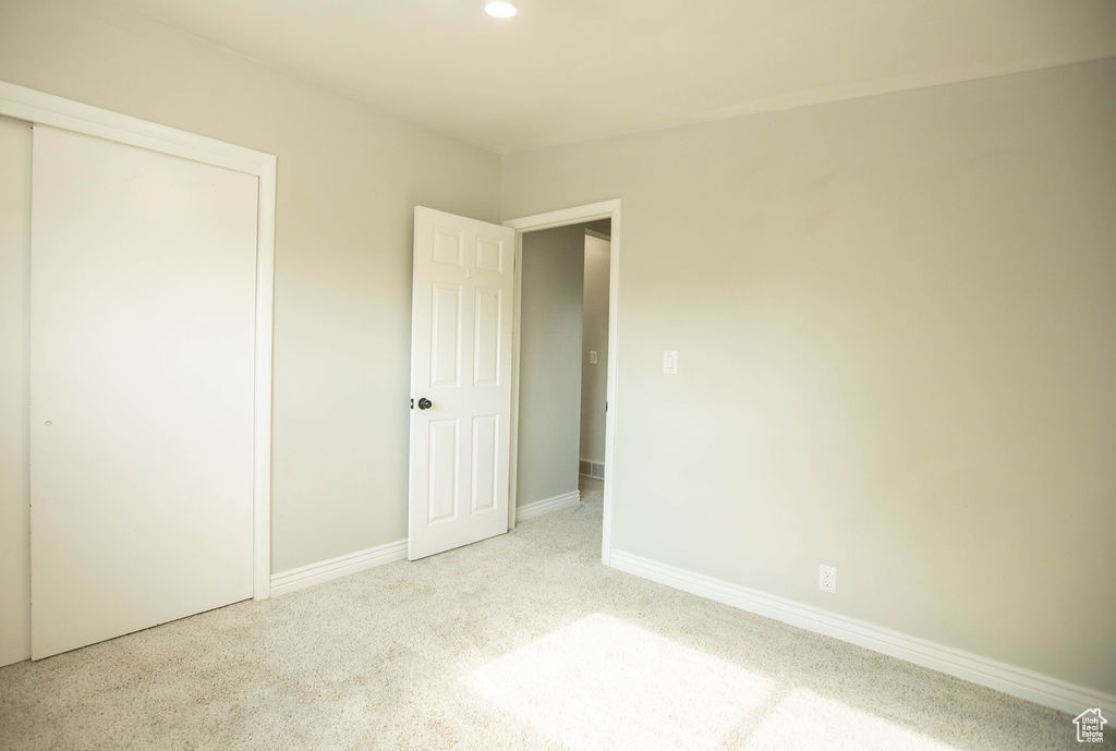 Unfurnished bedroom featuring a closet, carpet flooring, and recessed lighting
