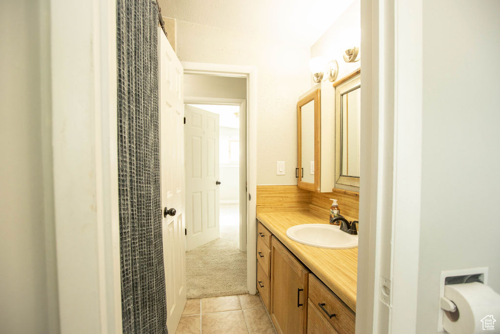 Bathroom with vanity and tile patterned flooring