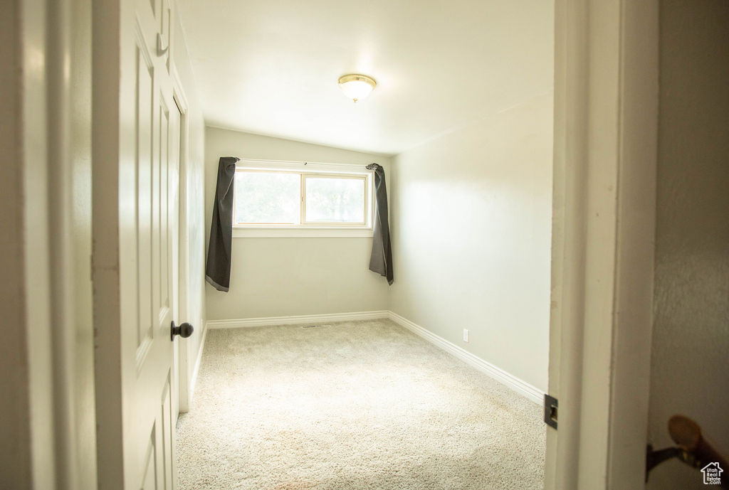 Empty room with carpet flooring and baseboards