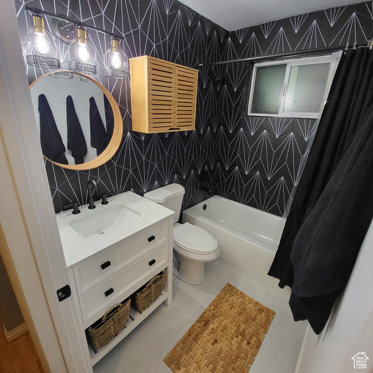 Full bathroom with vanity, tile patterned floors, shower / bath combo, and tile walls