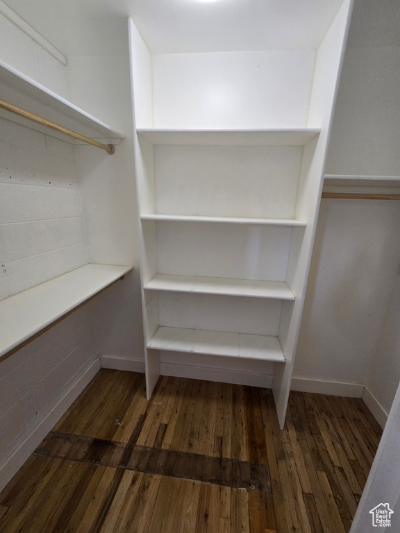 Walk in closet with wood finished floors
