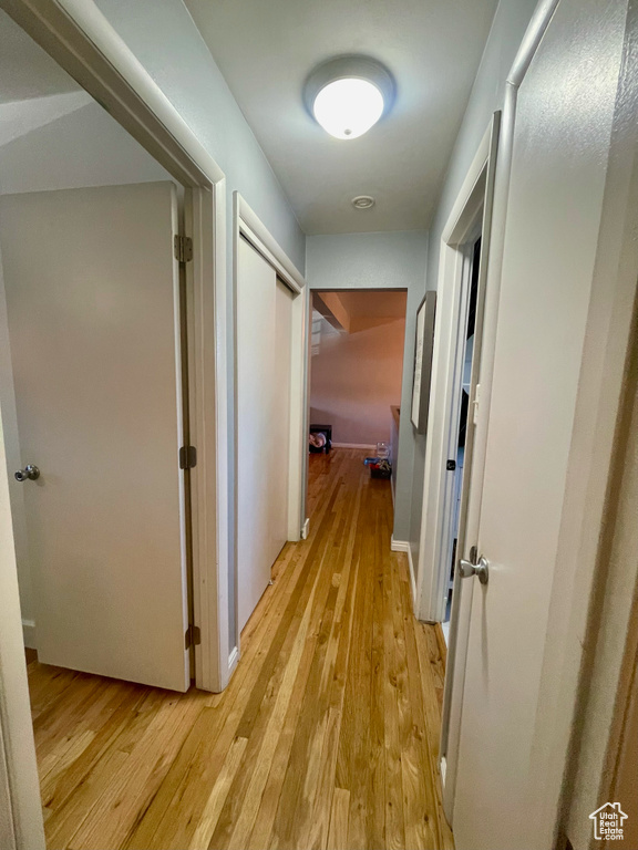 Hallway featuring light wood-style flooring