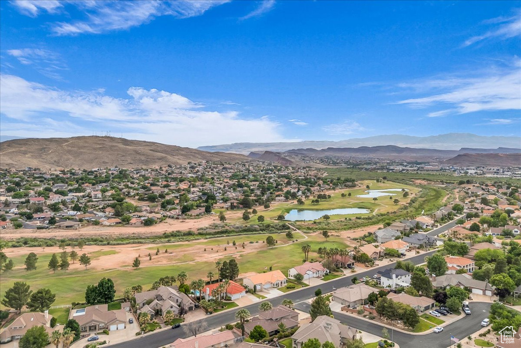 Aerial perspective of suburban area with a water and mountain view and a golf course