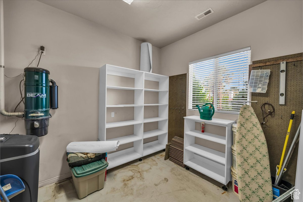 Miscellaneous room featuring unfinished concrete floors