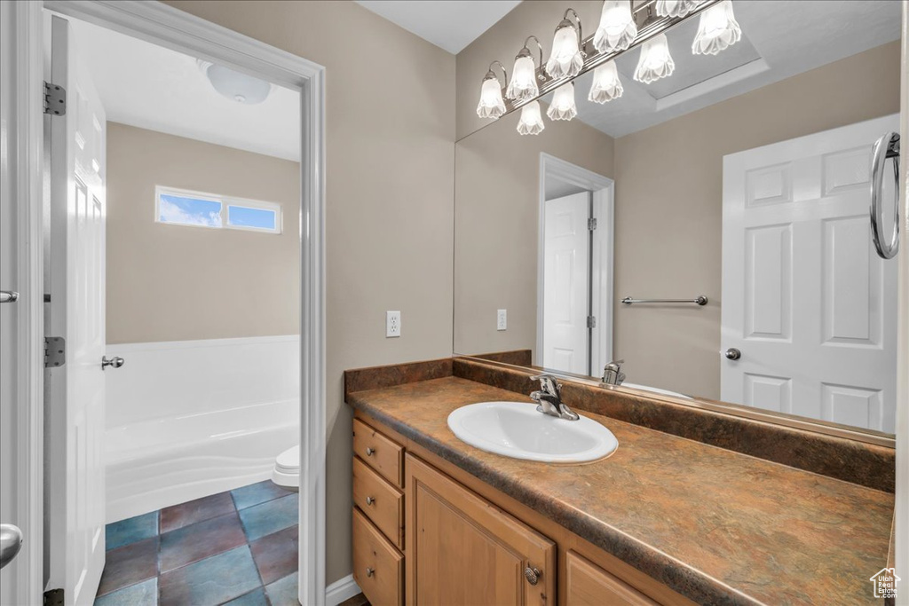 Bathroom featuring vanity and a bath