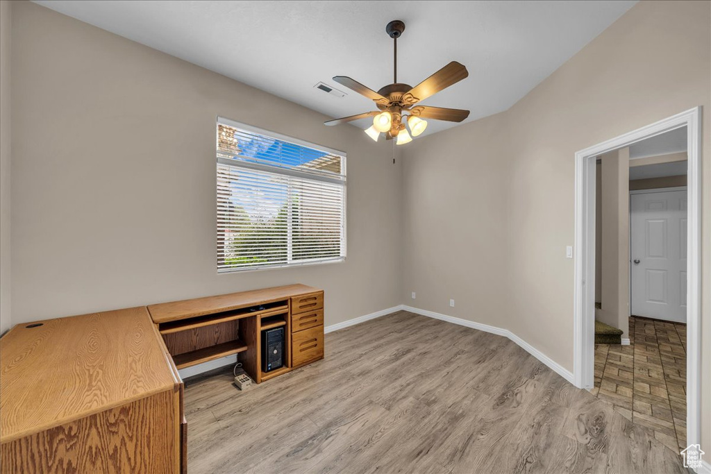 Unfurnished office featuring ceiling fan and light wood-style flooring