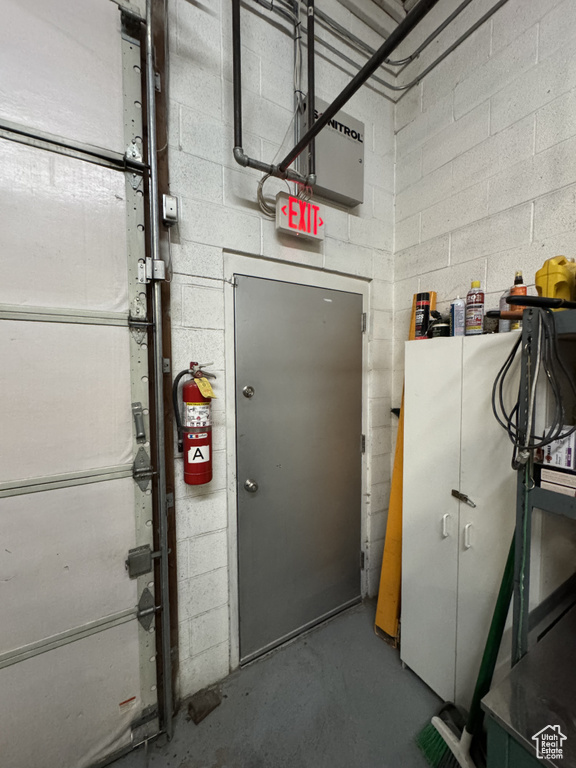 Garage featuring concrete block wall