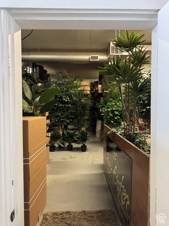 Corridor featuring concrete flooring