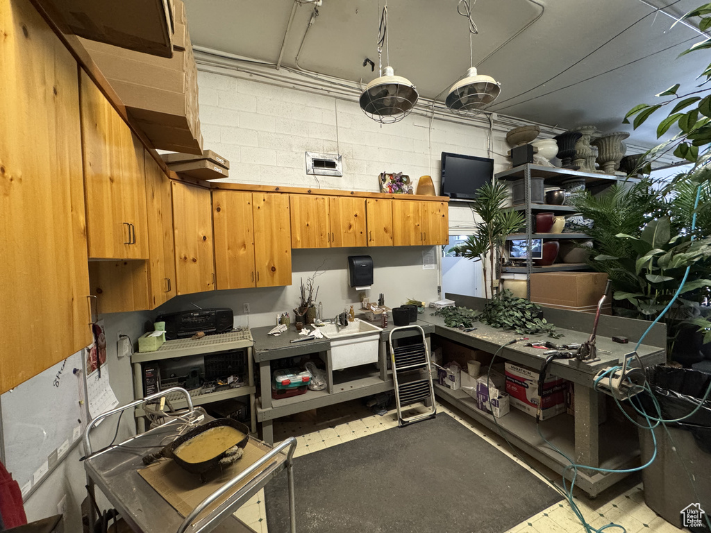 Kitchen with brown cabinets and concrete block wall
